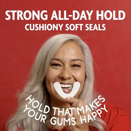 Woman smiling holding a denture adhesive with text about strong all-day hold.